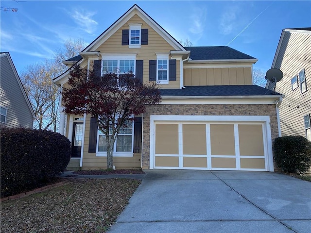 445 Pintail Ct, Suwanee, GA 30024 - traditional-style home featuring driveway, stone siding, board and batten siding, a garage, and a shingled roof