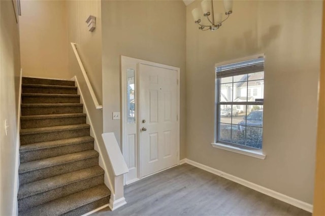 entrance foyer with a notable chandelier and hardwood / wood-style flooring