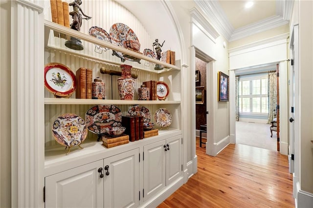 corridor with crown molding and light wood-type flooring