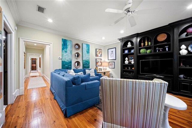 4524 Robert Dr, Valdosta, GA 31605 - living room with crown molding, a ceiling fan, visible vents, light wood finished floors, and baseboards