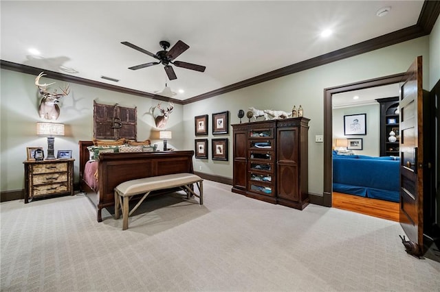 carpeted bedroom featuring ceiling fan and crown molding