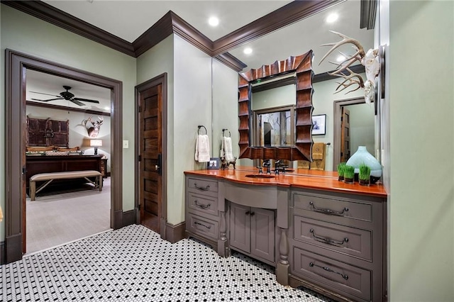 bathroom featuring ceiling fan, vanity, and crown molding