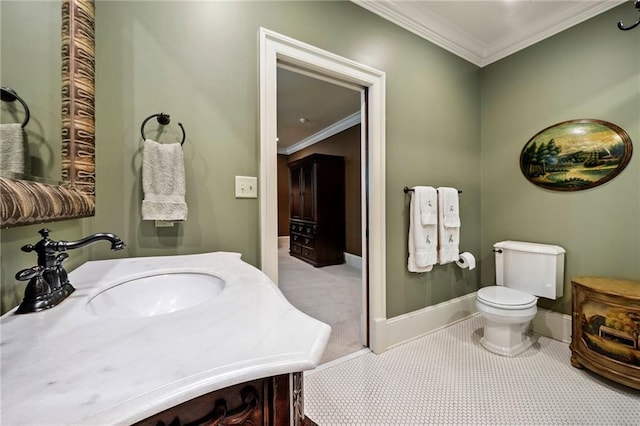 4524 Robert Dr, Valdosta, GA 31605 - half bathroom with vanity, baseboards, crown molding, and toilet