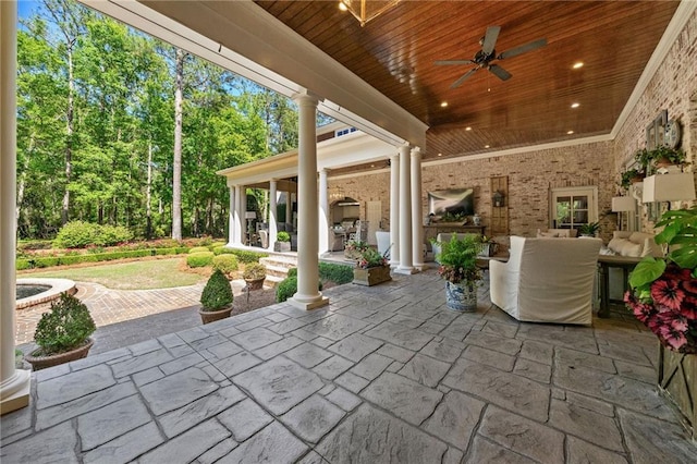 view of patio with exterior fireplace and ceiling fan