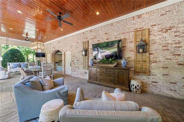 tiled living room featuring wood ceiling, ceiling fan, crown molding, and brick wall