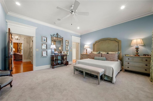 bedroom with carpet flooring, ceiling fan with notable chandelier, and crown molding