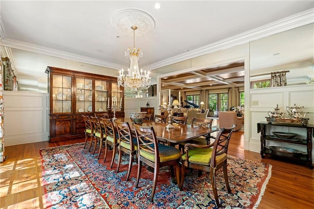 dining room with hardwood / wood-style flooring, coffered ceiling, a chandelier, and ornamental molding