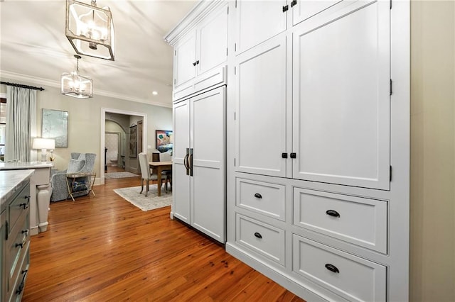 interior space featuring ornamental molding and light hardwood / wood-style flooring