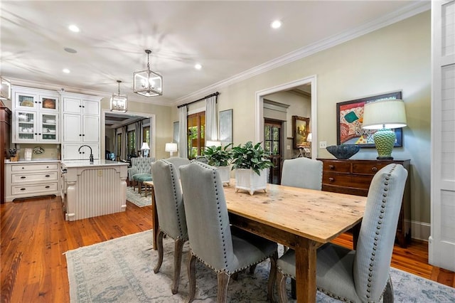 dining space with crown molding and hardwood / wood-style flooring