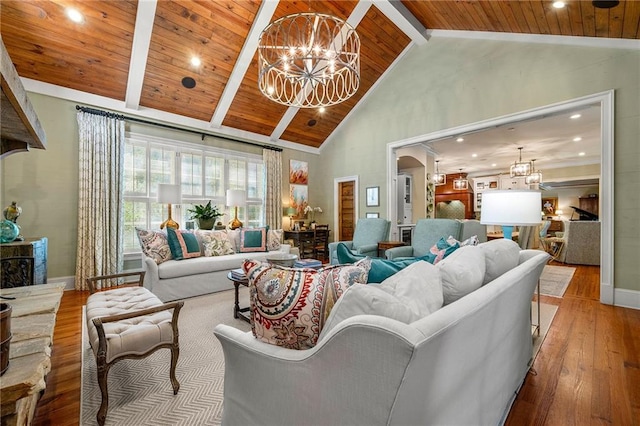 living room with high vaulted ceiling, hardwood / wood-style floors, wooden ceiling, a chandelier, and beam ceiling