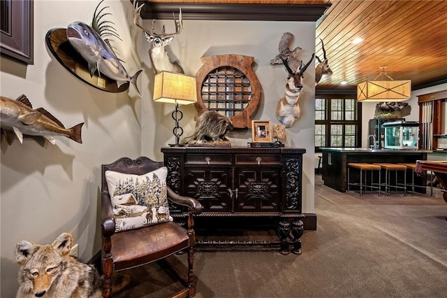 sitting room with wooden ceiling and carpet flooring