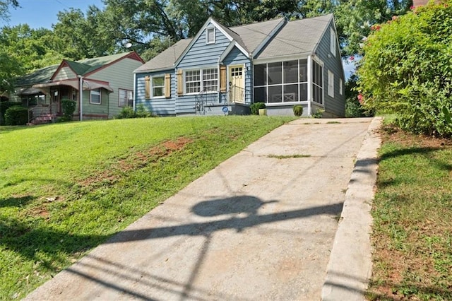 1649 Beecher St SW, Atlanta, GA 30310 - view of front of house with a sunroom, concrete driveway, and a front yard