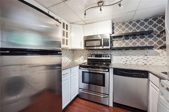 kitchen with decorative backsplash, light stone countertops, appliances with stainless steel finishes, and white cabinets