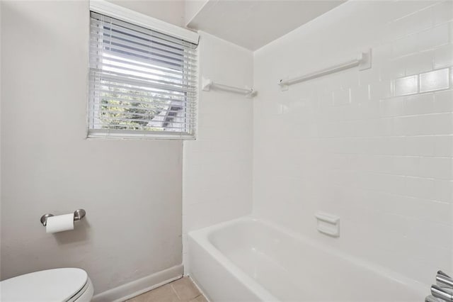 bathroom featuring tile patterned floors, bathtub / shower combination, toilet, and baseboards