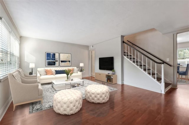 living room with stairway, baseboards, and wood finished floors