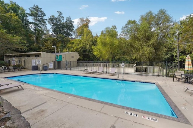 pool with a patio area, central AC, and fence