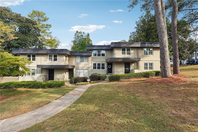 view of front facade featuring stucco siding and a front lawn