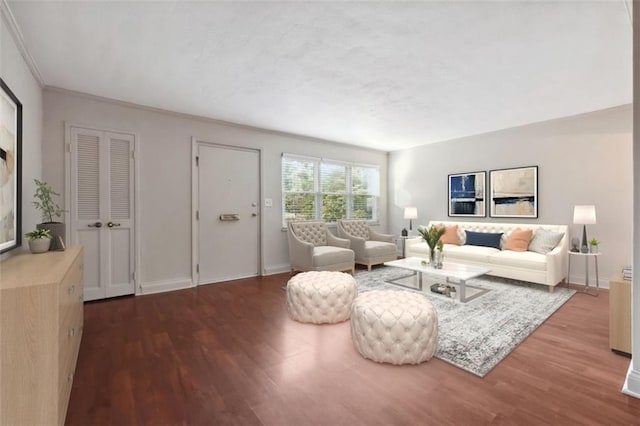 living area with wood finished floors, baseboards, and ornamental molding