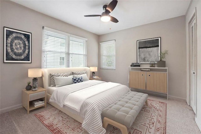 bedroom with a closet, light colored carpet, and baseboards