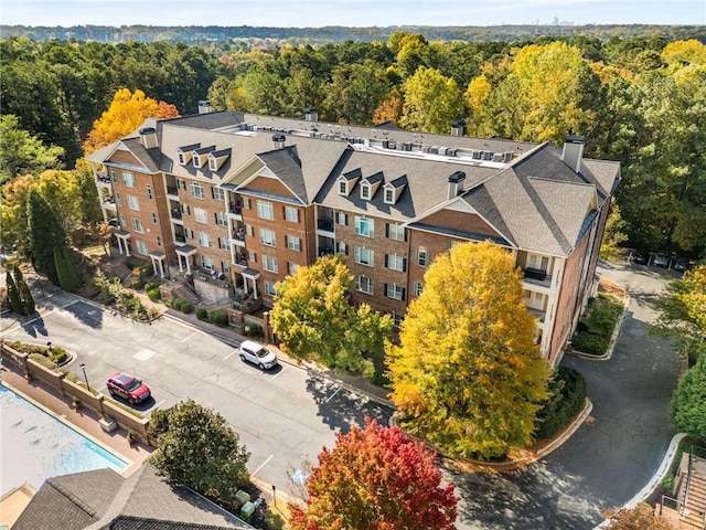 bird's eye view with a wooded view