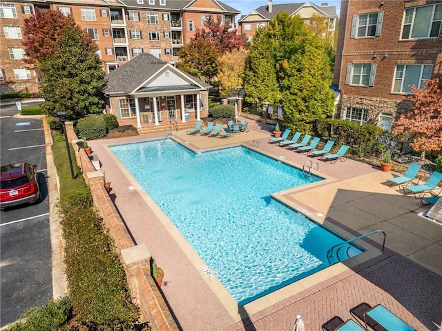 view of pool featuring an outbuilding and a patio area