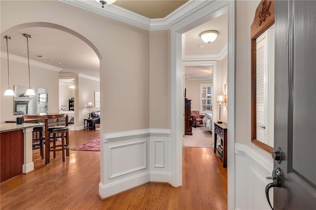 hall featuring ornamental molding and light wood-type flooring