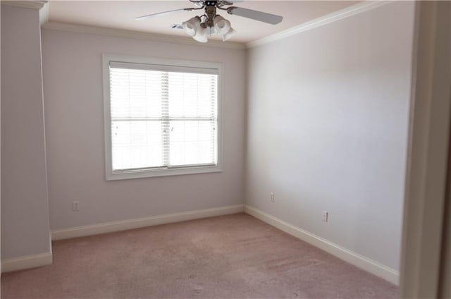 spare room featuring crown molding, light colored carpet, and ceiling fan