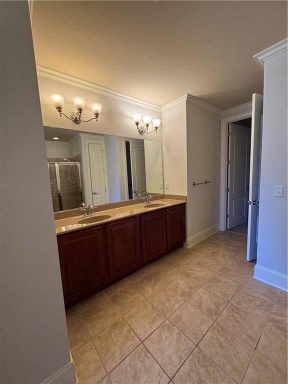 bathroom with double vanity, a stall shower, ornamental molding, and a sink