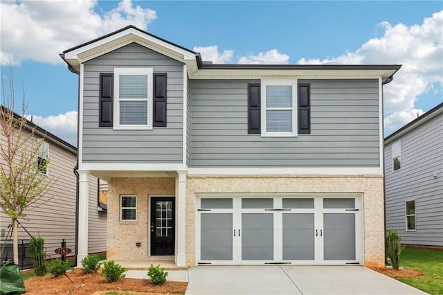 view of front of property with an attached garage, board and batten siding, brick siding, and driveway