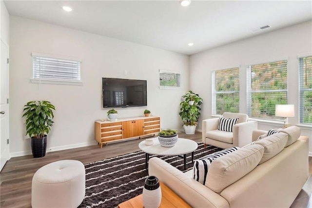 living area with baseboards, recessed lighting, visible vents, and wood finished floors
