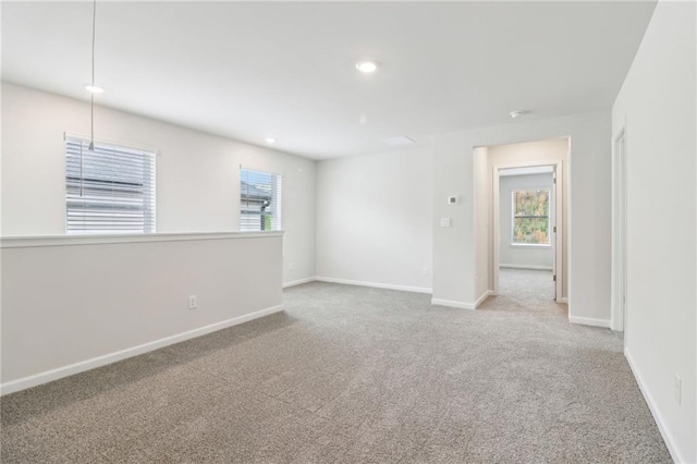 empty room with carpet flooring, a healthy amount of sunlight, and recessed lighting