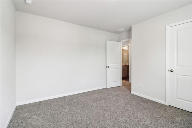 unfurnished bedroom with carpet flooring and baseboards