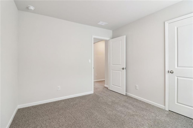 unfurnished bedroom with carpet and baseboards