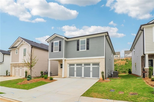view of front of home featuring central AC unit, a front yard, an attached garage, and driveway