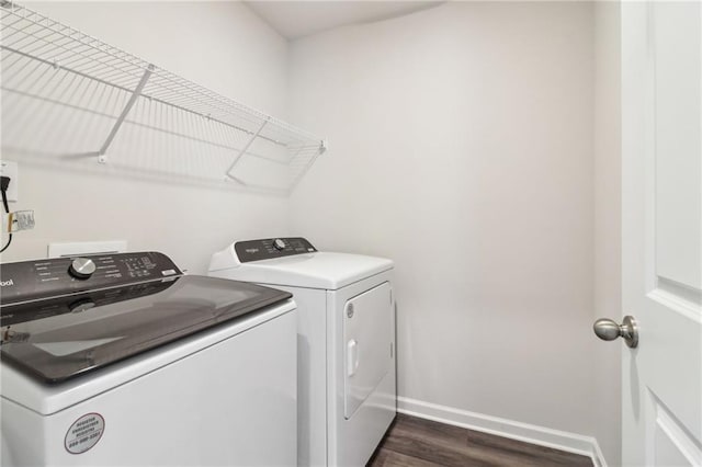 laundry room featuring washer and dryer, laundry area, dark wood finished floors, and baseboards