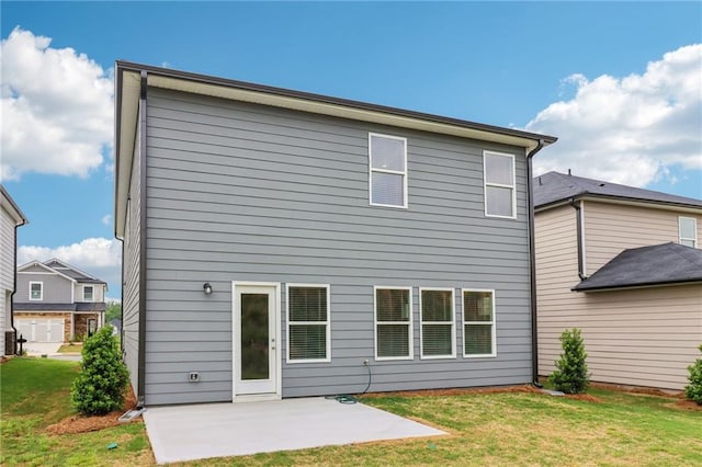 back of property with a yard and a patio area