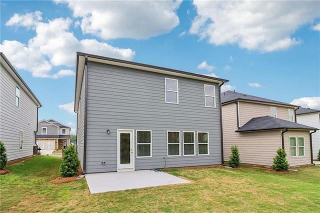 rear view of house with a yard and a patio