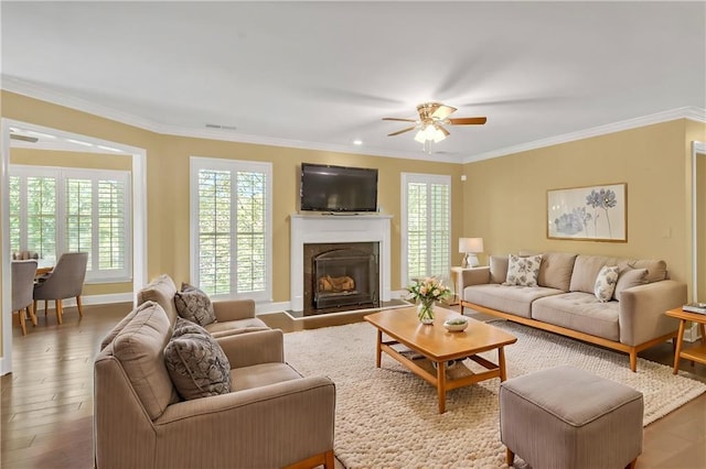 living room with crown molding, wood-type flooring, and ceiling fan