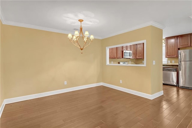 interior space with crown molding, a notable chandelier, and hardwood / wood-style flooring