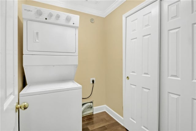 washroom featuring crown molding and stacked washer / drying machine