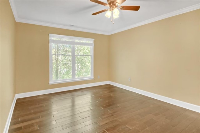 spare room with ceiling fan, ornamental molding, and dark hardwood / wood-style flooring