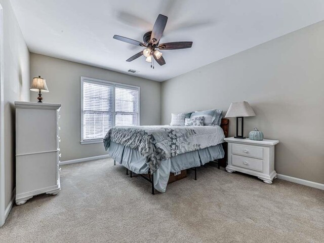 bedroom featuring light colored carpet and ceiling fan