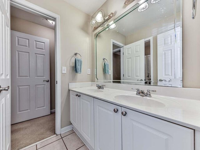 bathroom with tile patterned floors and vanity