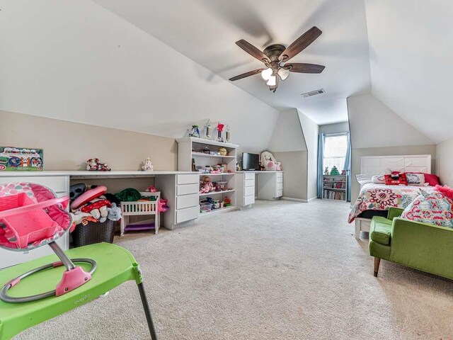 bedroom with ceiling fan, carpet floors, and vaulted ceiling