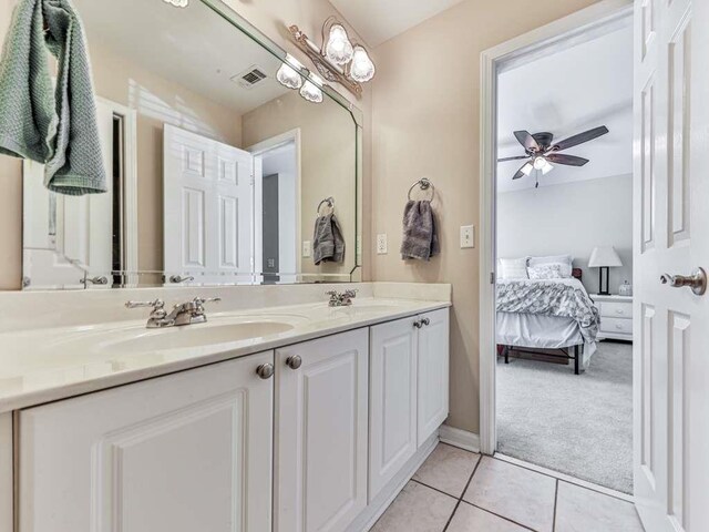 bathroom with ceiling fan, tile patterned flooring, and vanity