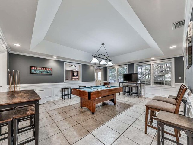 game room featuring light tile patterned floors, ornamental molding, pool table, and a tray ceiling