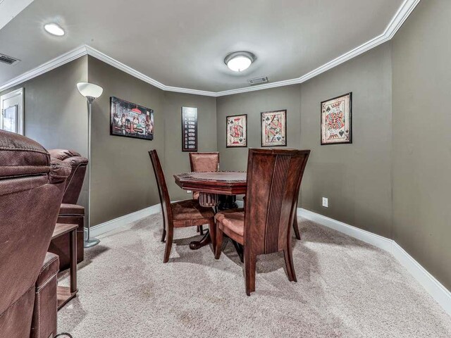 carpeted dining space with crown molding