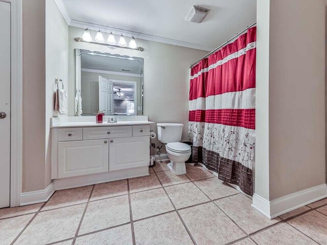 bathroom featuring vanity, crown molding, tile patterned flooring, toilet, and walk in shower