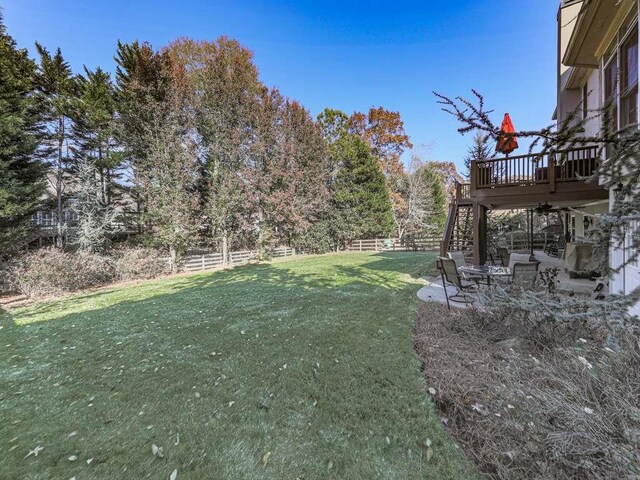 view of yard featuring a patio area and a deck