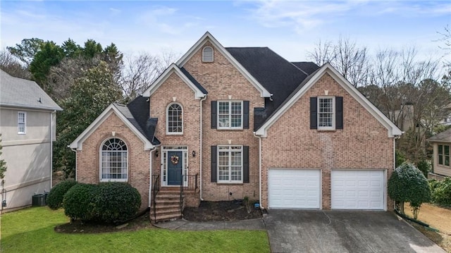 view of front of house featuring brick siding, central air condition unit, an attached garage, driveway, and a front lawn